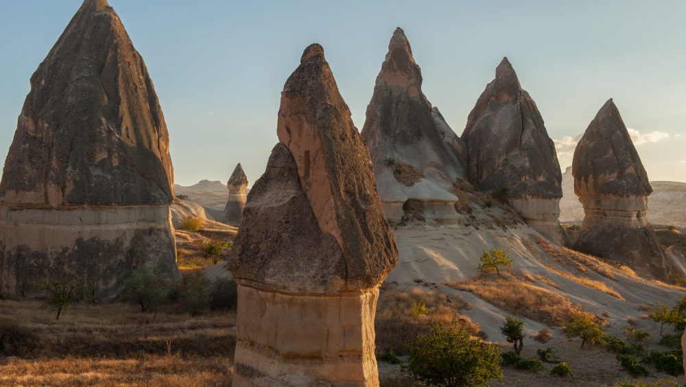 a group of tall rocks in a desert