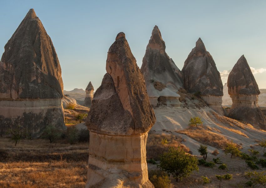a group of tall rocks in a desert